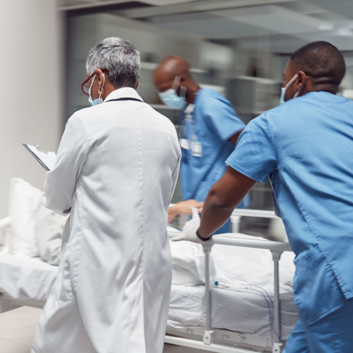 A doctor and nurses rushing a patient to the OR